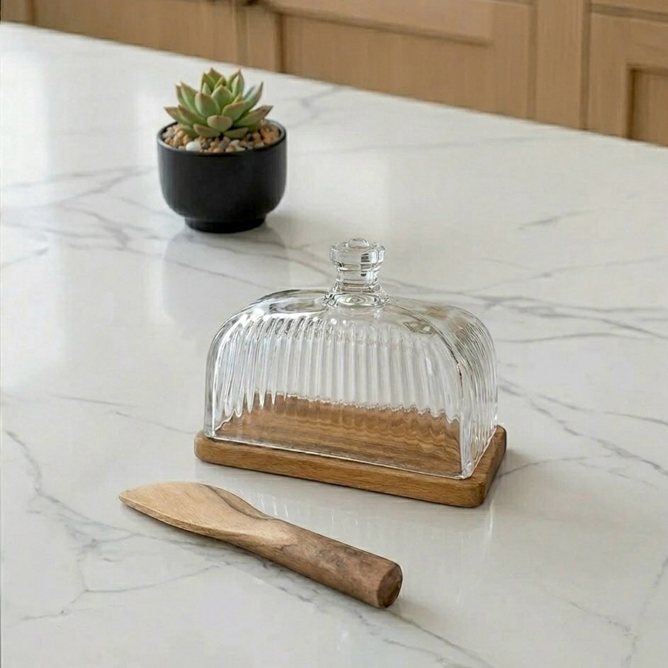 Glass dome butter dish with a rich wood base and matching wood butter knife 